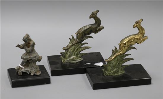 A pair of Art Deco deer bookends and a lead figure of a flute player